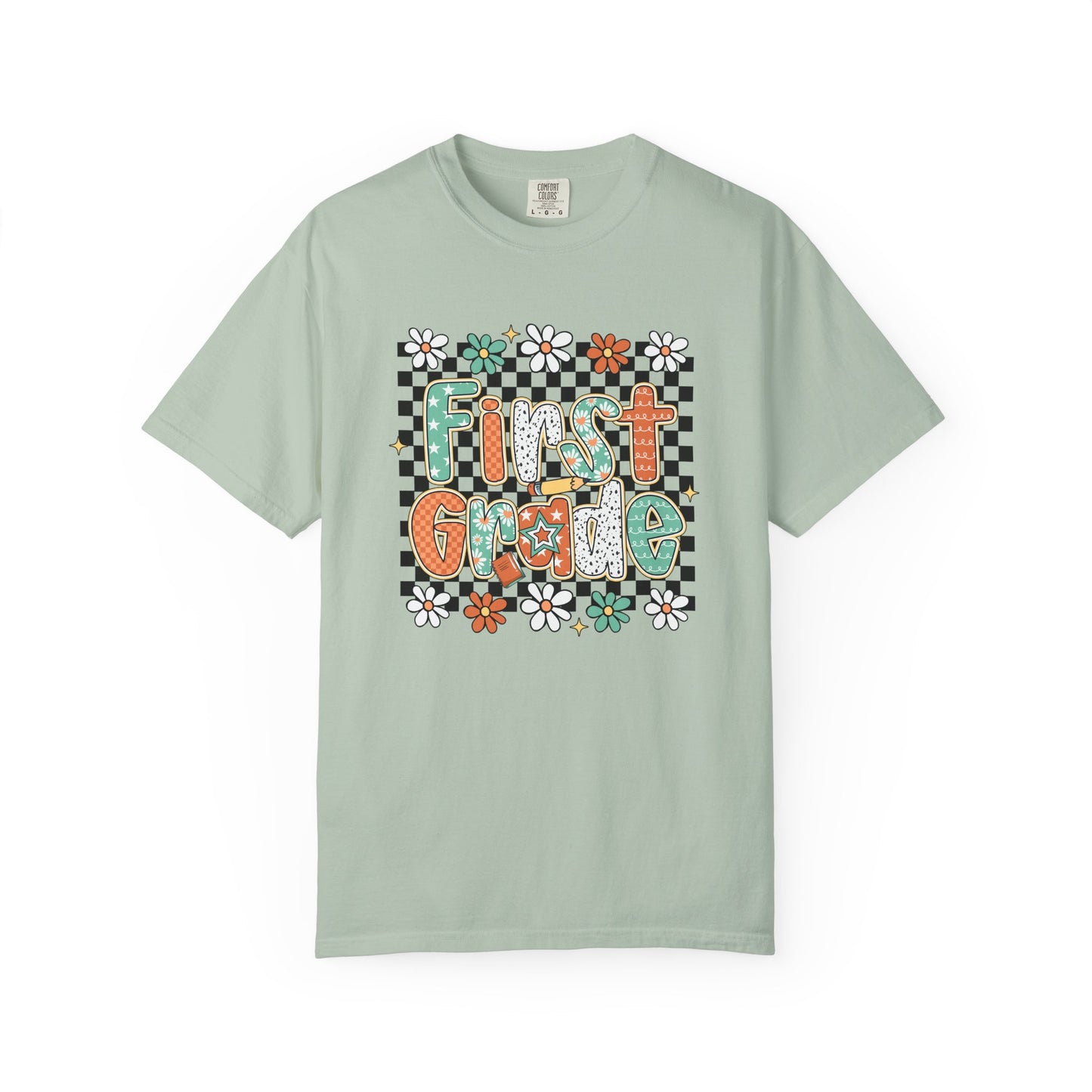 Light green t-shirt with 'First Grade' text and floral design on a white background