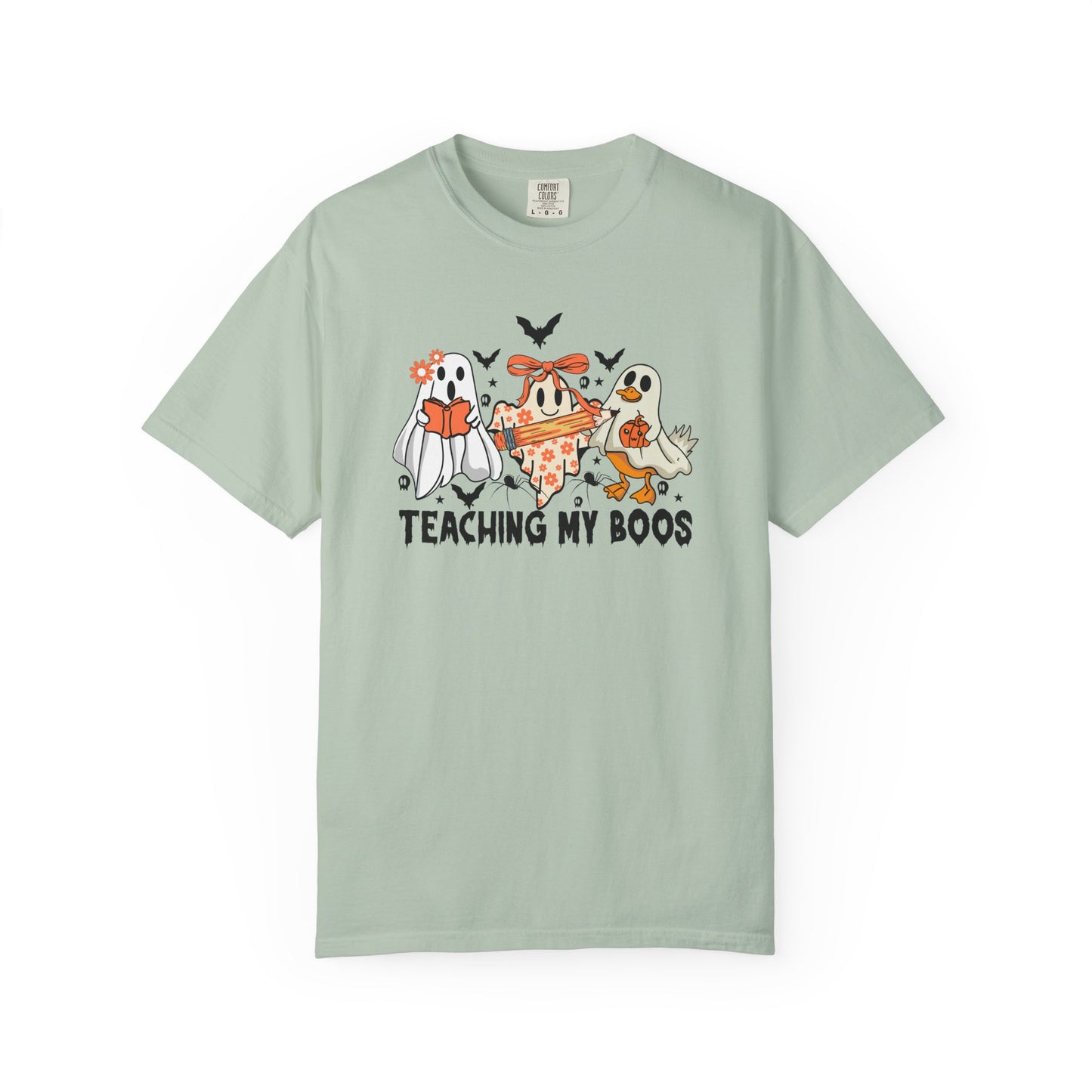 Light green t-shirt with Halloween-themed graphic and text 'Teaching My Boos' on a white background